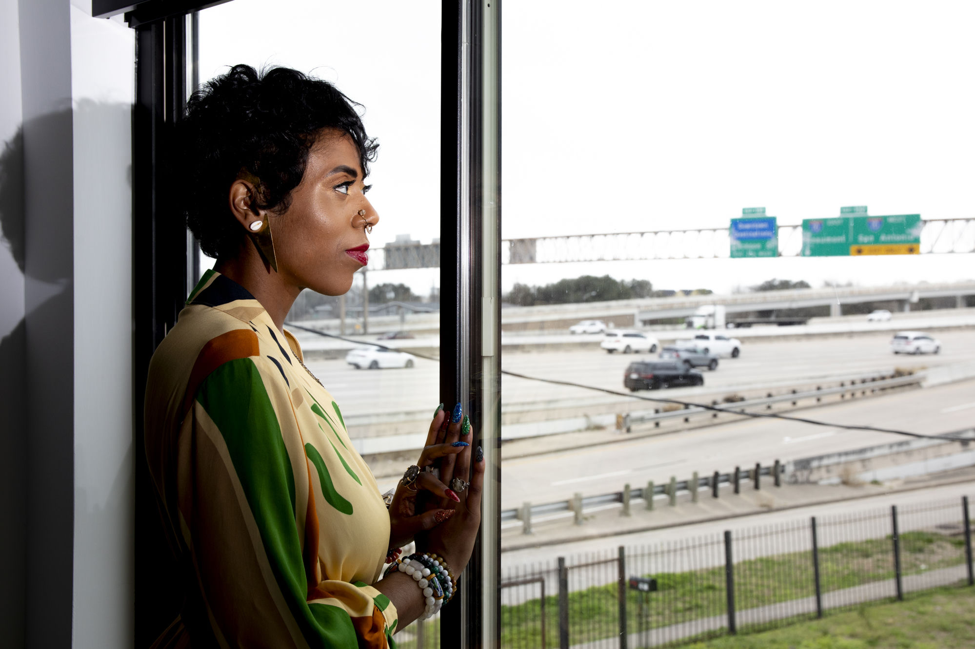 Christa Stoneham looking out at Houston from a window